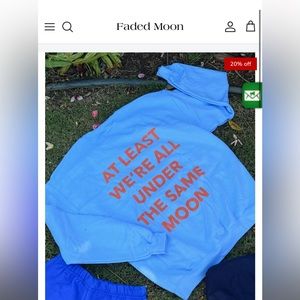 A light blue and orange Faded moon crewneck size 2XL. Very good condition.